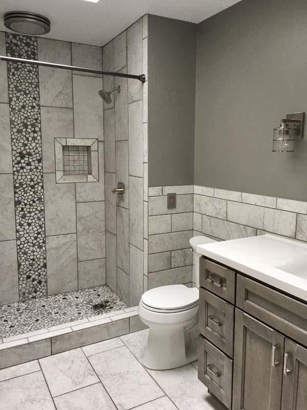 Bathroom with tiled walk-in shower and pebble accent
