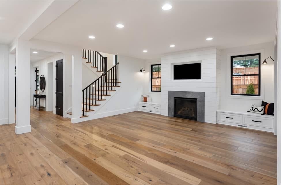 Bright remodeled living room with wood floors and built-ins