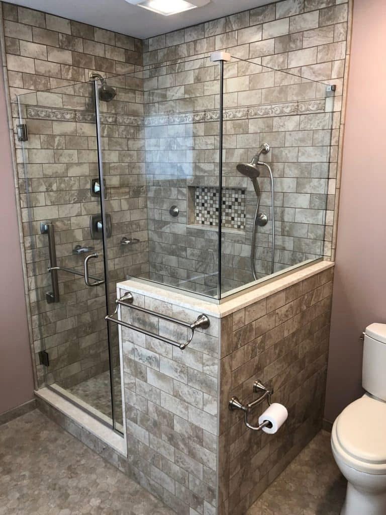 Tiled accessible shower with glass enclosure and grab bars
